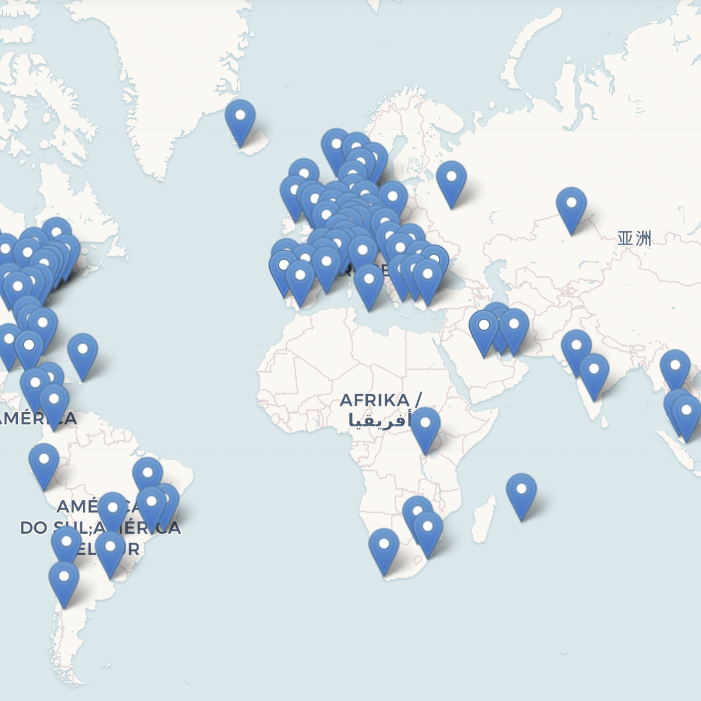 A world map with many blue location pins clustered in Europe, some in the Americas, a few in Africa and Asia, indicating multiple marked points. Labels on the map use different languages.